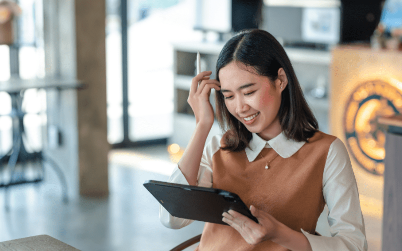 ChatGPT: Mujer asiática sonriendo a su tableta